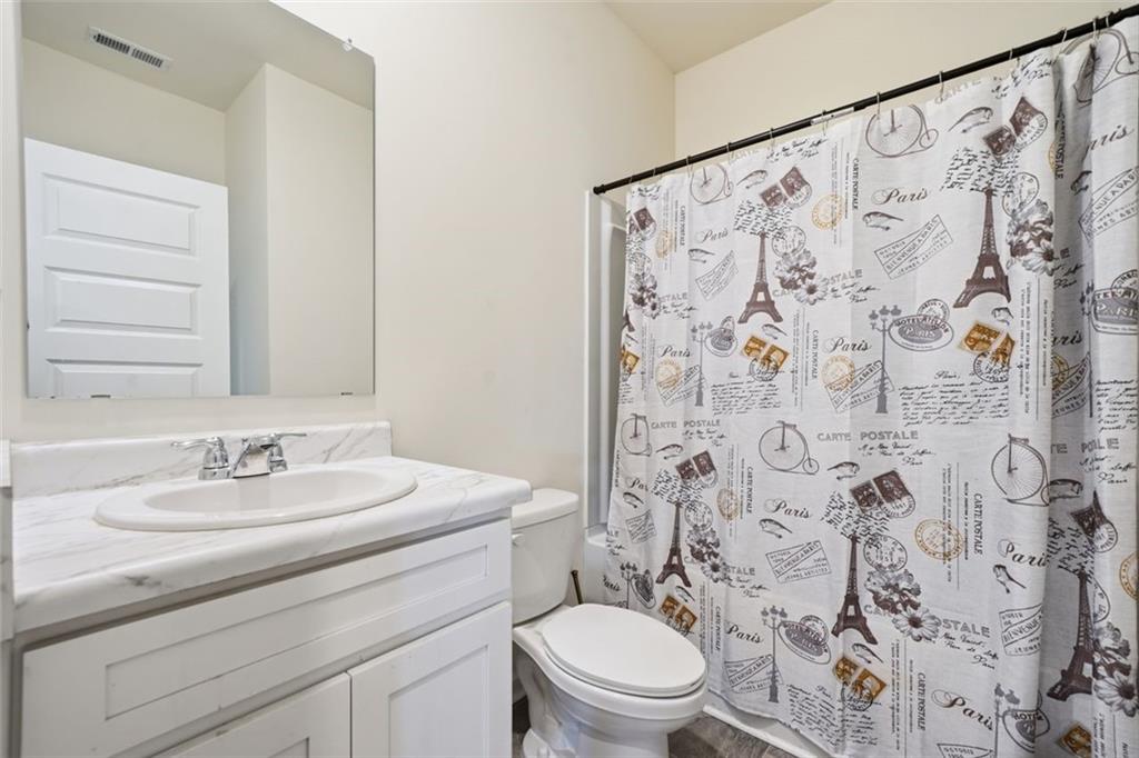 469 Ralph Still Road Dacula, GA 30019 - Photo 17 of 42 a bathroom with a sink and a mirror