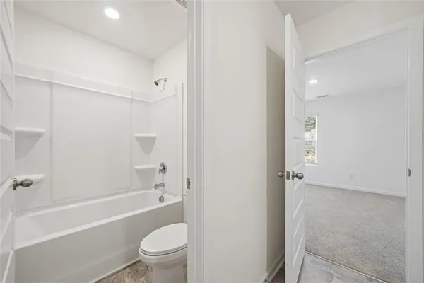 a bathroom with a bathtub toilet and a shower