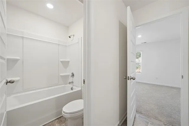 a bathroom with a bathtub toilet and a shower