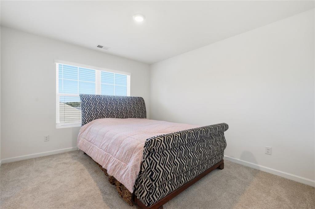 469 Ralph Still Road Dacula, GA 30019 - Photo 26 of 42 a bedroom with a bed and window