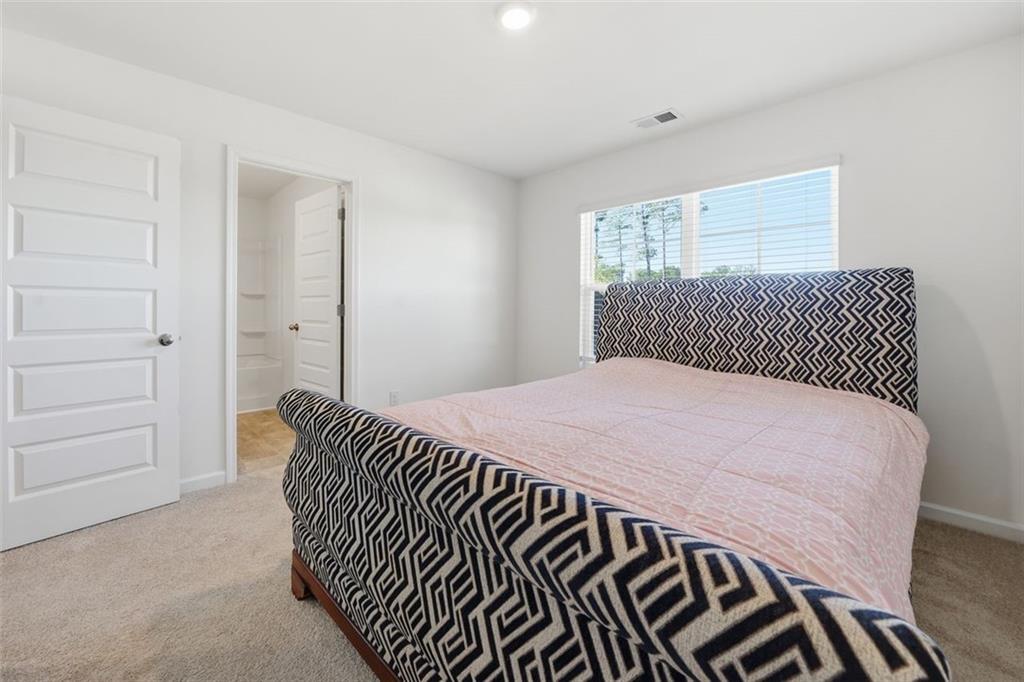 469 Ralph Still Road Dacula, GA 30019 - Photo 27 of 42 a bedroom with a bed and a dresser