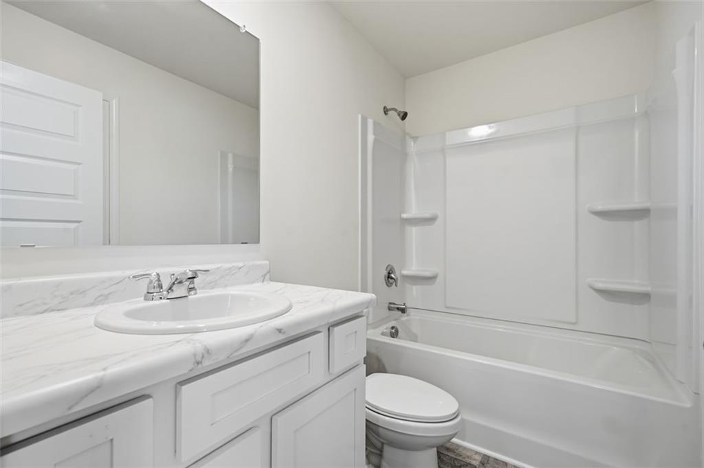 469 Ralph Still Road Dacula, GA 30019 - Photo 28 of 42 a bathroom with a sink a toilet and shower