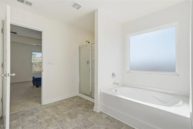 a bathroom with a bathtub and a shower