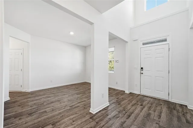 a view of an empty room with wooden floor