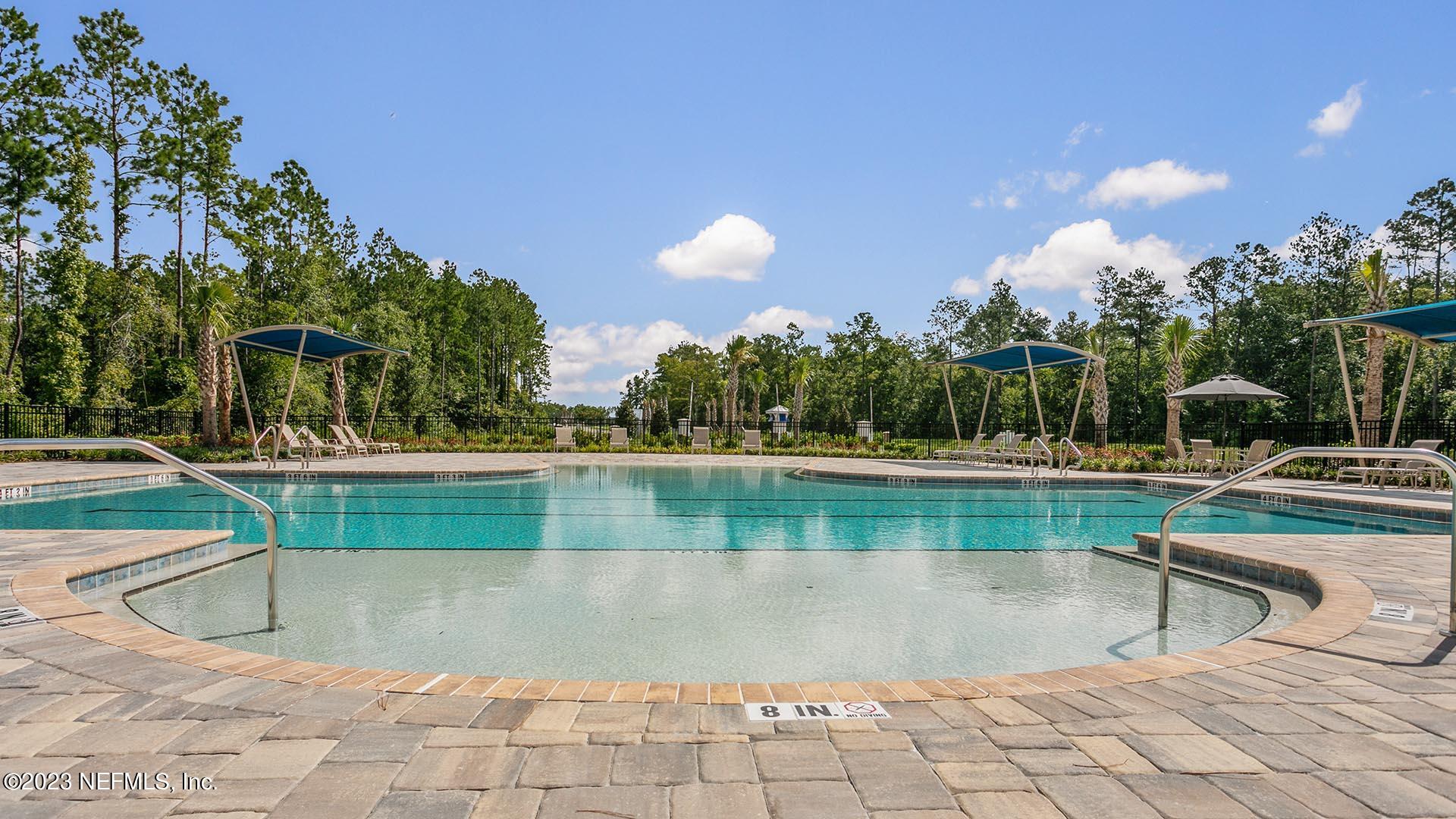 120 Java Lane St. Augustine, FL 32092 - Photo 23 of 37 a view of a swimming pool with a chair and tables