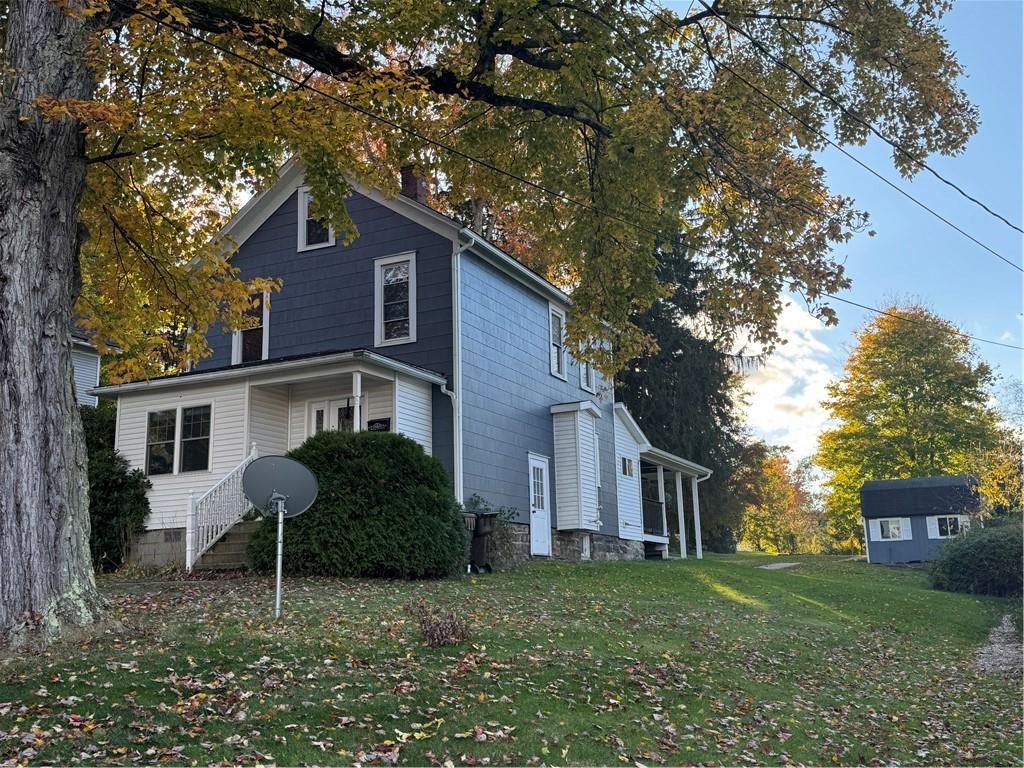 a house that has a tree in front of the house