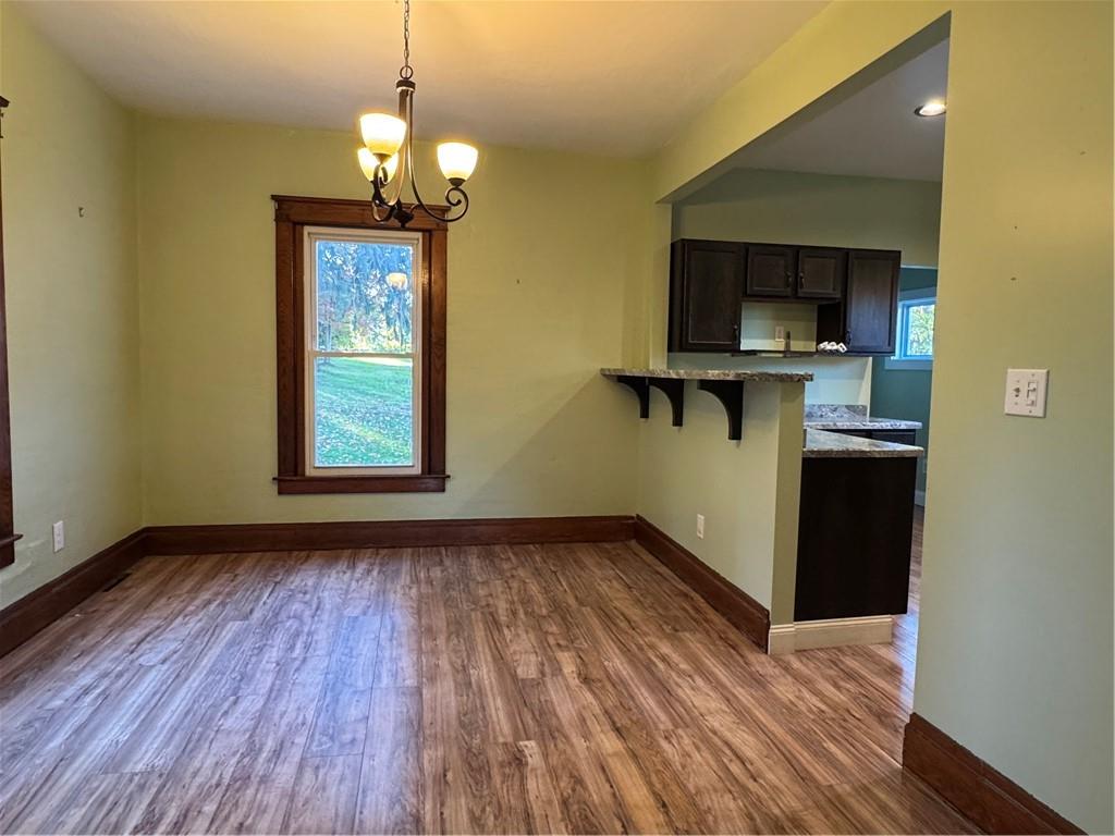 351 North Pitt Street Mercer, PA 16137 - Photo 17 of 39 a view of empty room with kitchen and wooden floor
