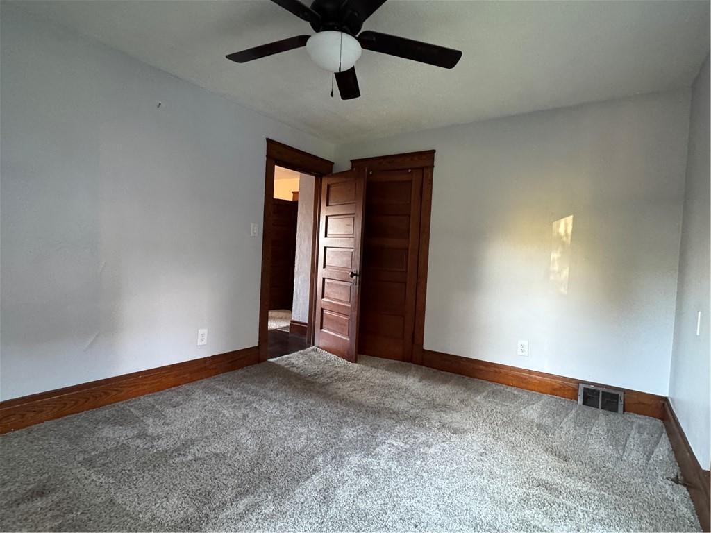 351 North Pitt Street Mercer, PA 16137 - Photo 26 of 39 an empty room with a ceiling fan and carpet