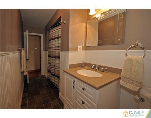 3028 Cheesequake Road Old Bridge, NJ 08859 - Photo 12 of 16 a bathroom with a sink and a mirror