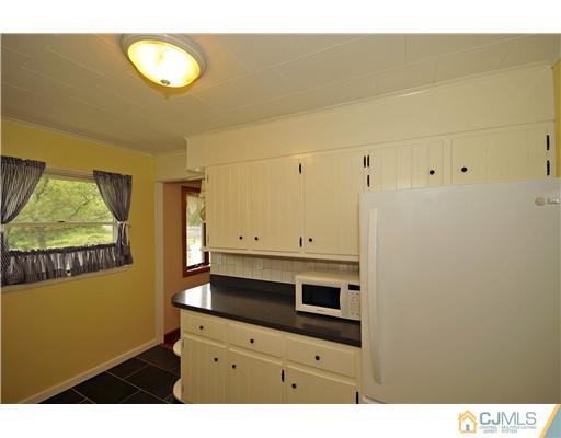 3028 Cheesequake Road Old Bridge, NJ 08859 - Photo 5 of 16 a view of cabinets and wooden floor