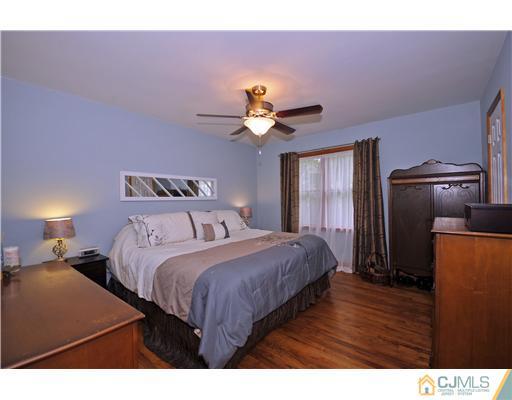 3028 Cheesequake Road Old Bridge, NJ 08859 - Photo 8 of 16 a bedroom with a bed and a chandelier