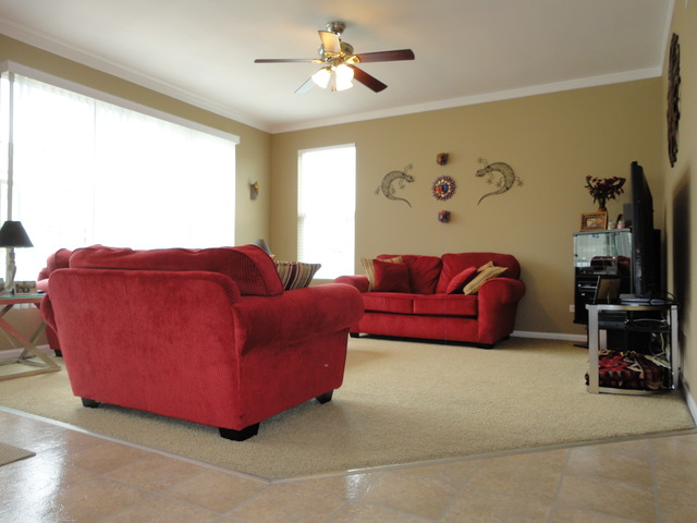 1407 Roth Drive Joliet, IL 60431 - Photo 3 of 25 a living room with furniture a ceiling fan and a large window