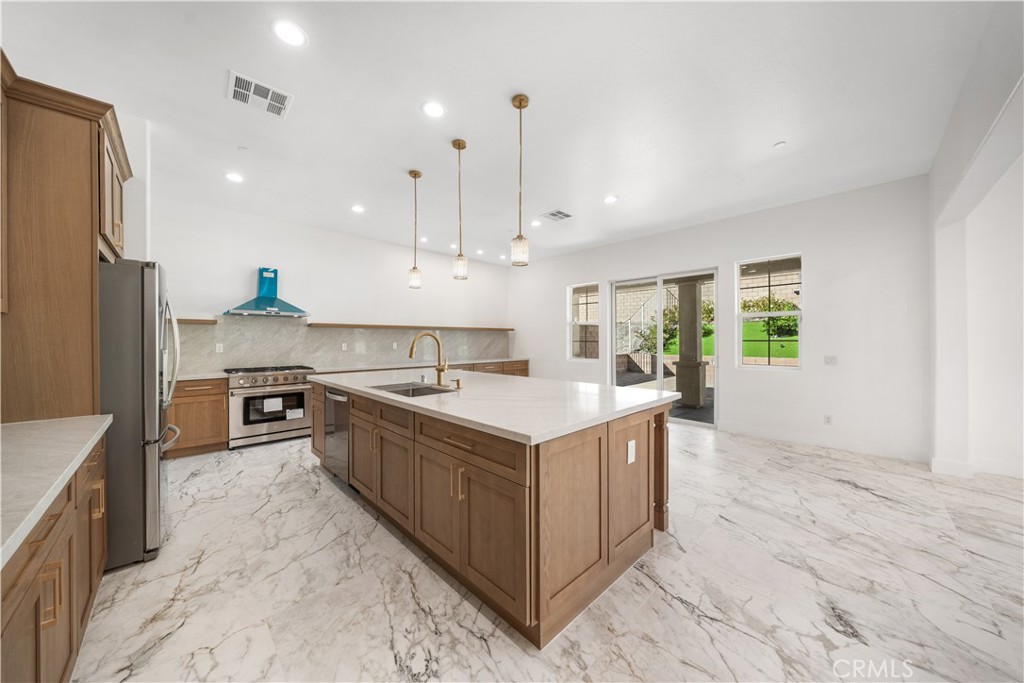 12210 Alamo Drive Rancho Cucamonga, CA 91739 - Photo 11 of 53 a kitchen with stainless steel appliances granite countertop a sink a stove and a refrigerator