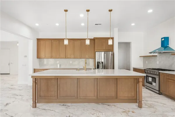 a kitchen with a stove a sink and a refrigerator