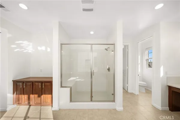a bathroom with a sink double vanity granite tub and a mirror
