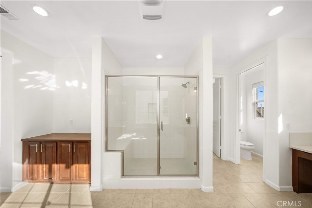 12210 Alamo Drive Rancho Cucamonga, CA 91739 - Photo 25 of 53 a bathroom with a shower and a toilet