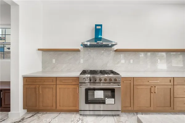 a stove top oven sitting inside of a kitchen
