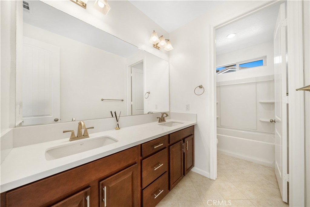 12210 Alamo Drive Rancho Cucamonga, CA 91739 - Photo 31 of 53 a bathroom with a sink double vanity granite tub and a mirror
