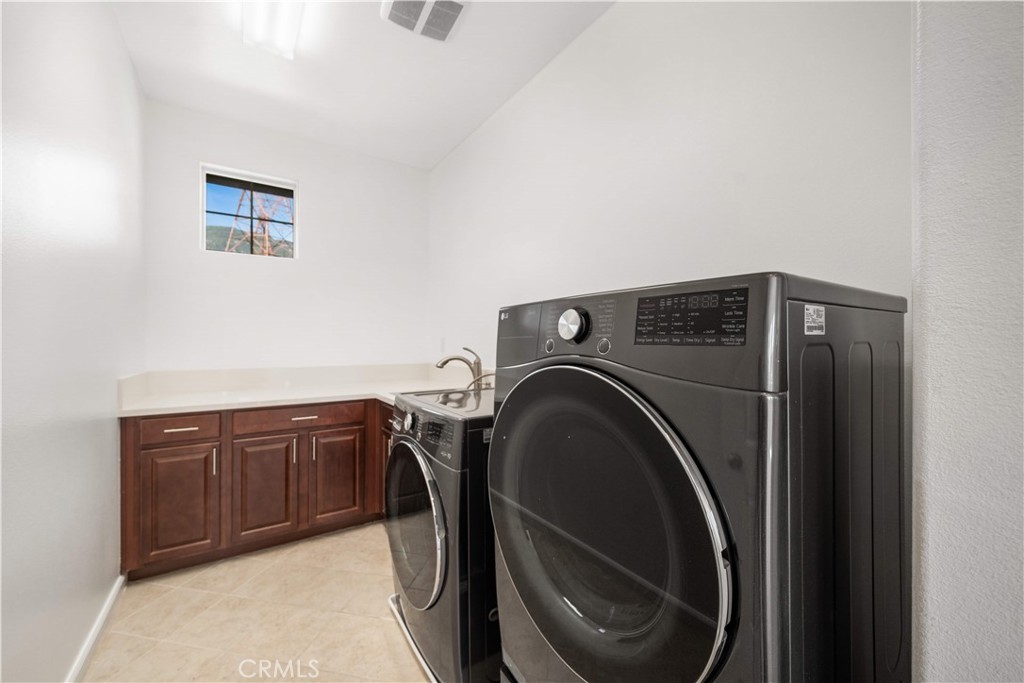 12210 Alamo Drive Rancho Cucamonga, CA 91739 - Photo 36 of 53 a view of a storage and utility room with washer and dryer