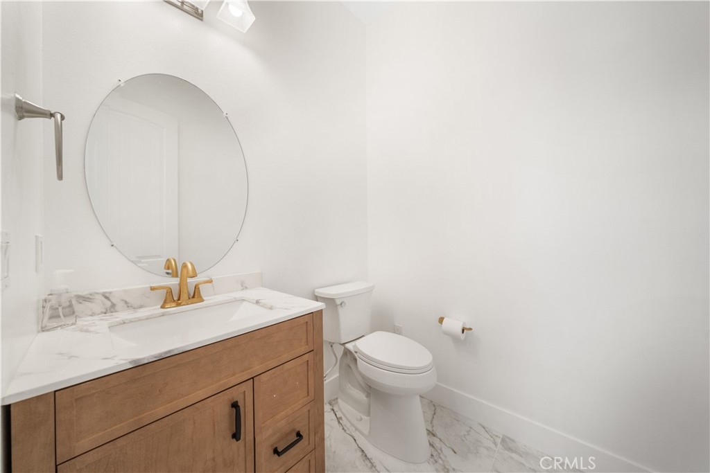 12210 Alamo Drive Rancho Cucamonga, CA 91739 - Photo 37 of 53 a bathroom with a toilet sink and mirror