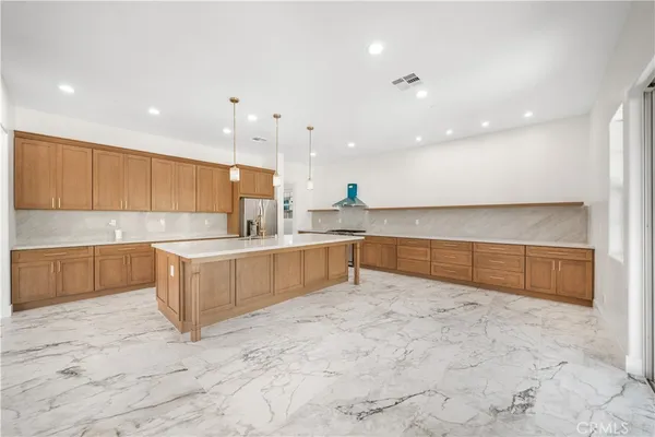 a large kitchen with a lot of counter space and a sink