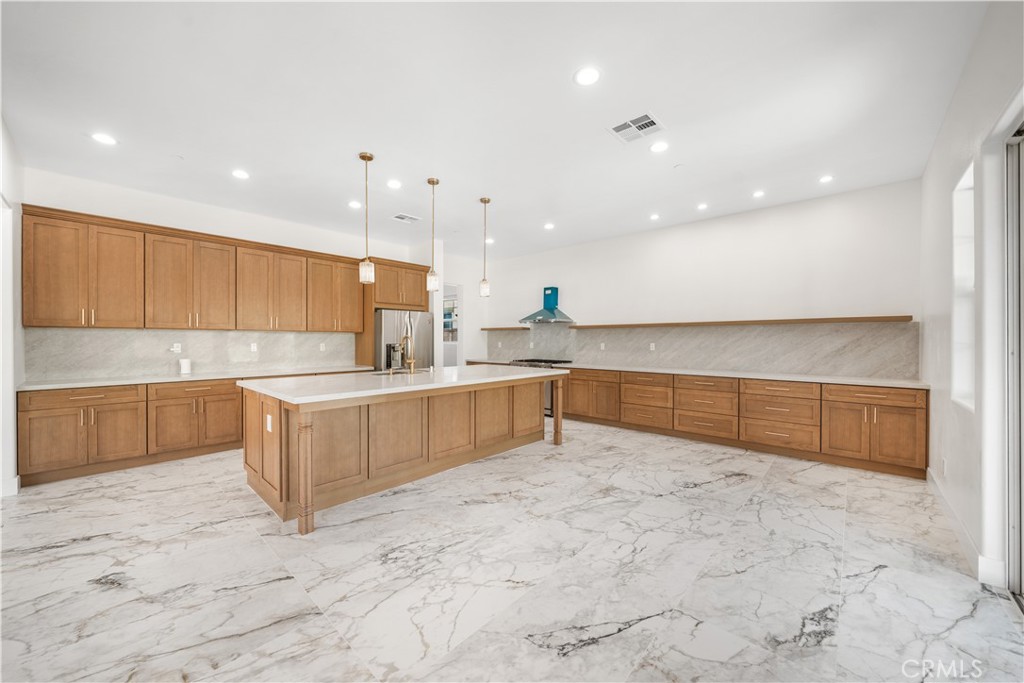 12210 Alamo Drive Rancho Cucamonga, CA 91739 - Photo 4 of 53 a large kitchen with a lot of counter space and a sink