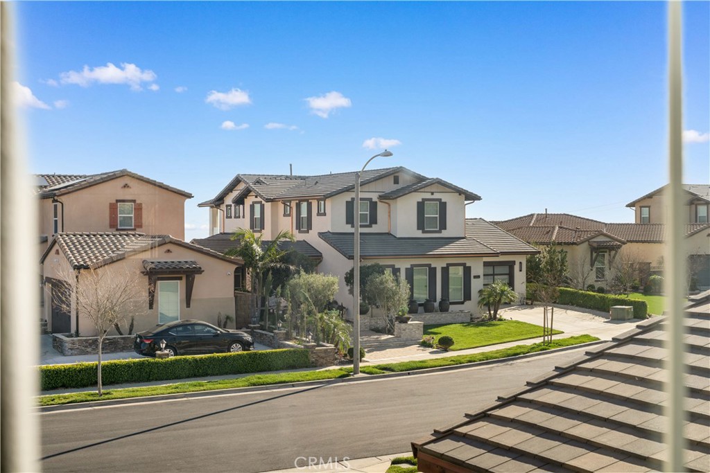 12210 Alamo Drive Rancho Cucamonga, CA 91739 - Photo 44 of 53 a view of a white house with a swimming pool and yard