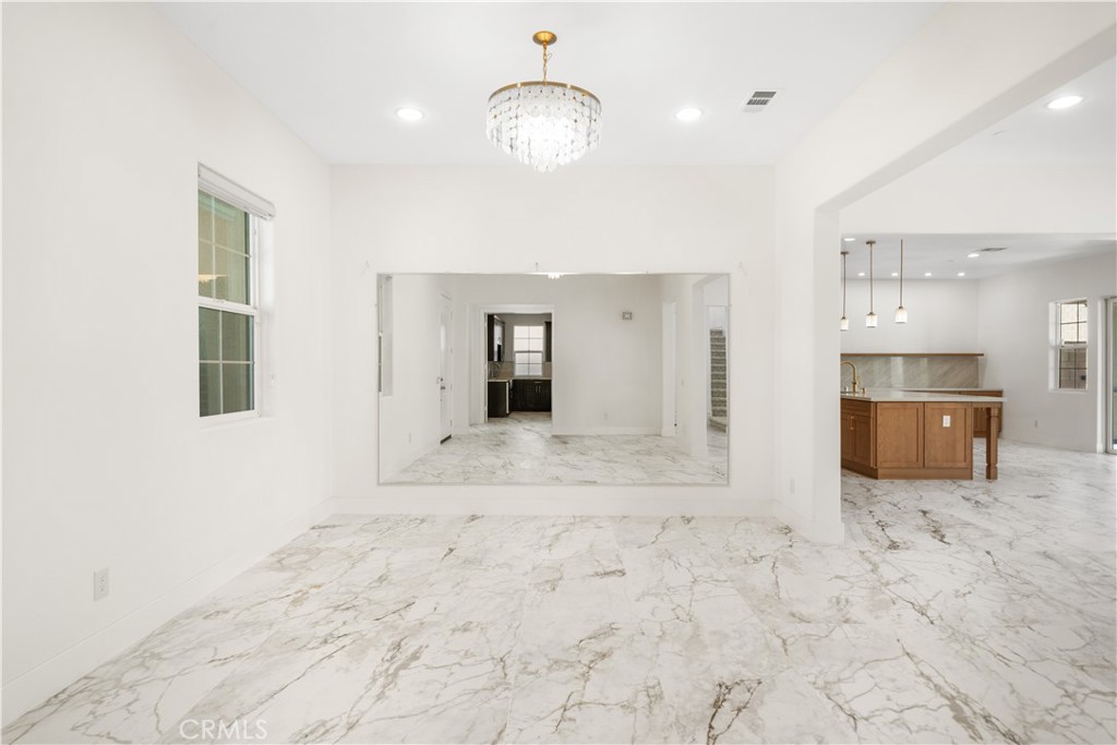 12210 Alamo Drive Rancho Cucamonga, CA 91739 - Photo 6 of 53 a view of a hallway with wooden floor and a kitchen