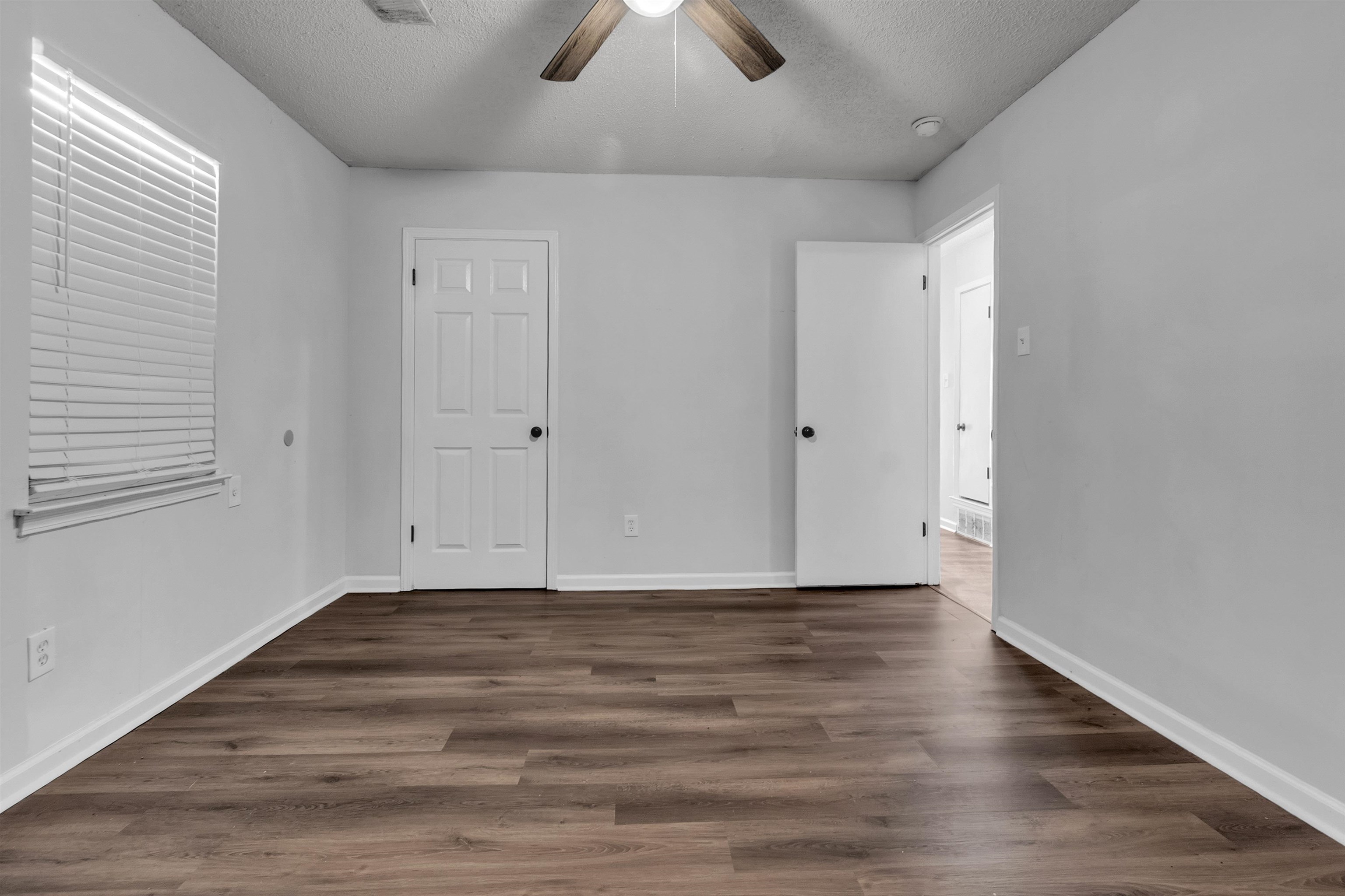 1532 Silver Street Memphis, TN 38106 - Photo 5 of 14 a view of an empty room with window and wooden floor