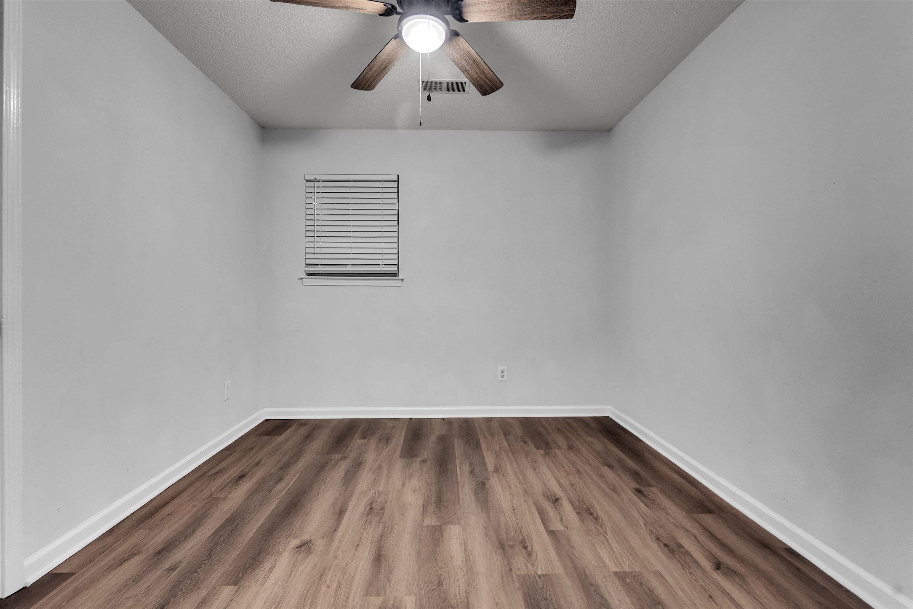 1532 Silver Street Memphis, TN 38106 - Photo 6 of 14 a view of room with wooden floor and ceiling fan