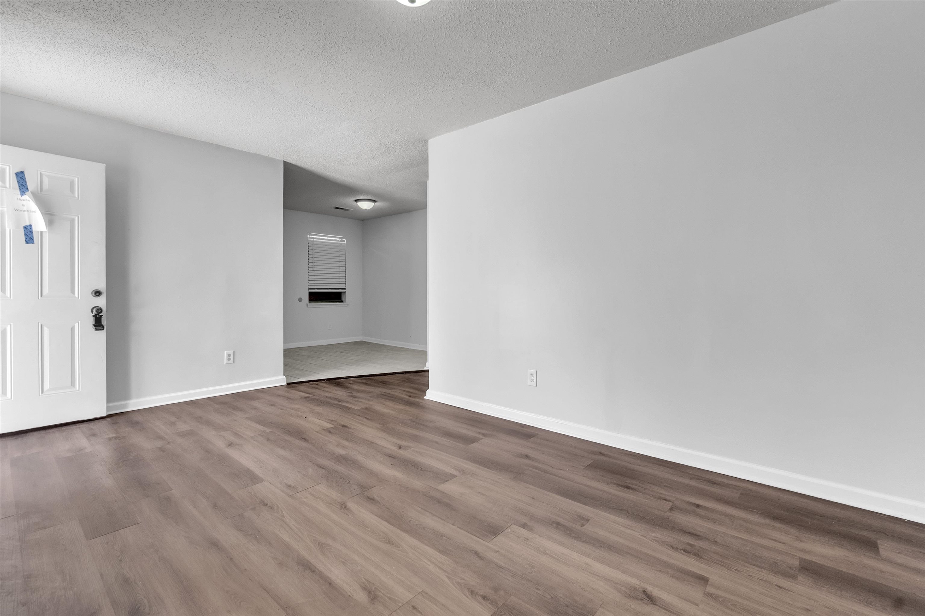 1532 Silver Street Memphis, TN 38106 - Photo 8 of 14 a view of an empty room with wooden floor and closet