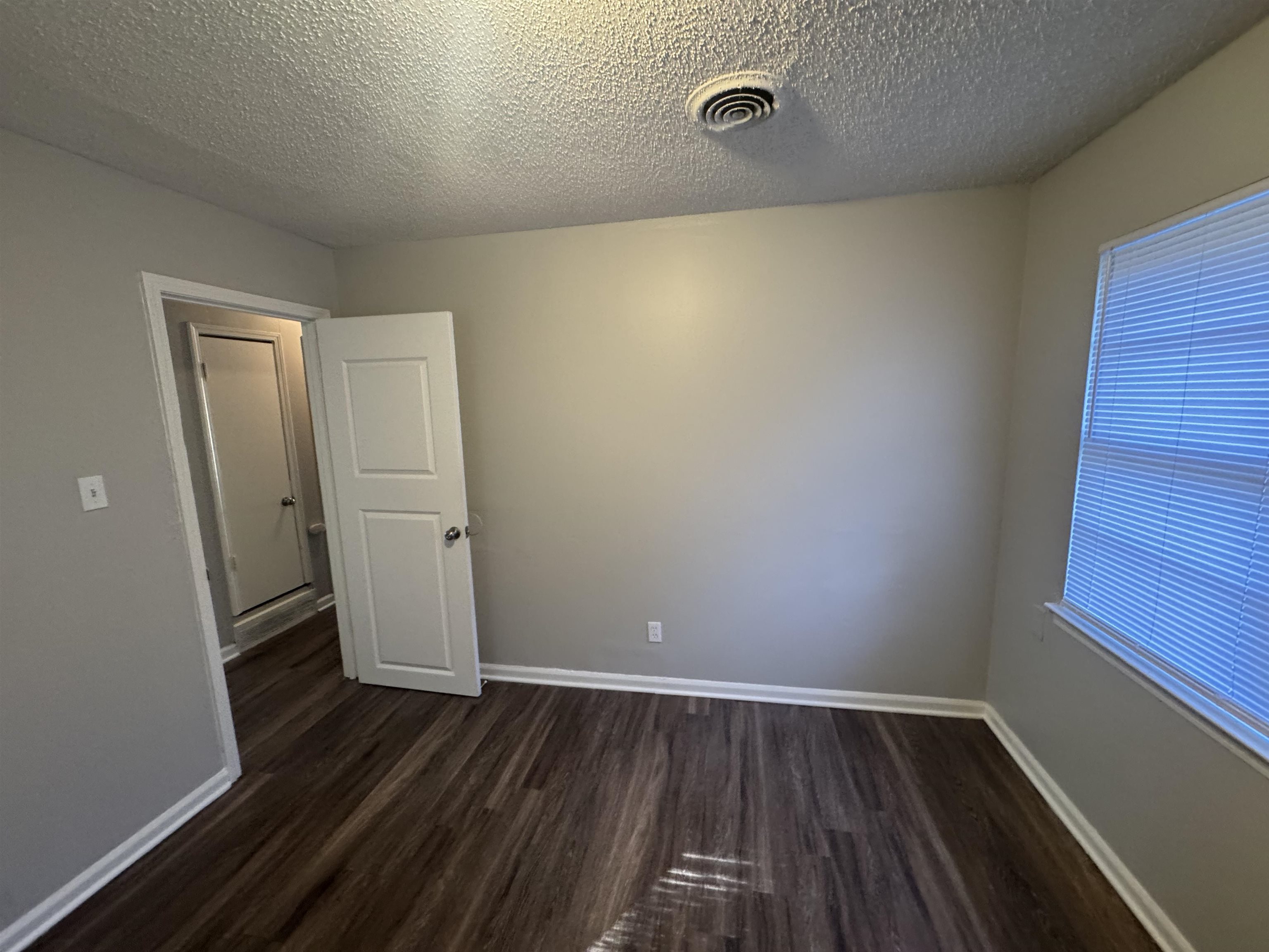 745 Harahan Road Memphis, TN 38109 - Photo 15 of 15 an empty room with wooden floor and windows