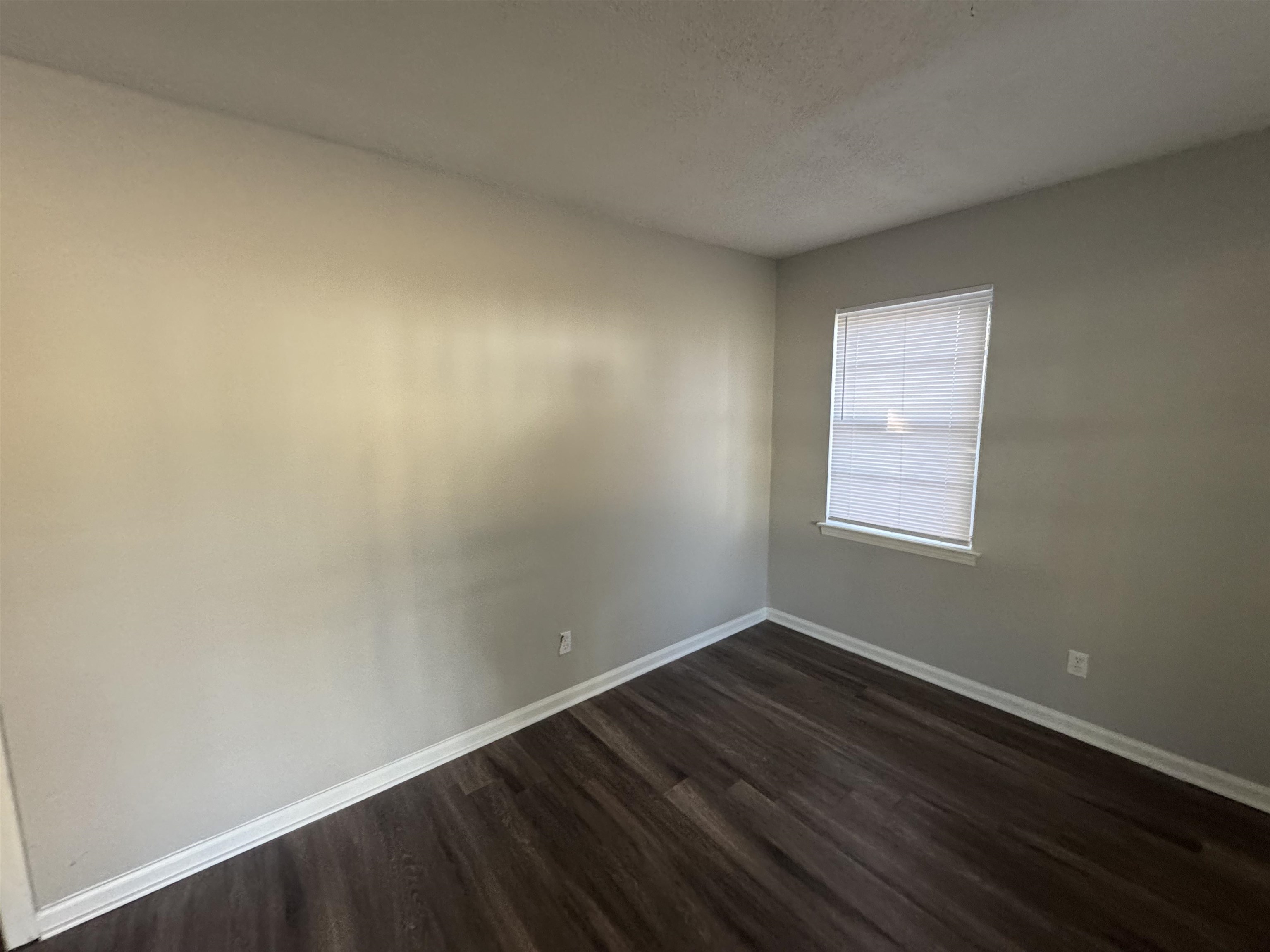 745 Harahan Road Memphis, TN 38109 - Photo 4 of 15 an empty room with wooden floor and windows