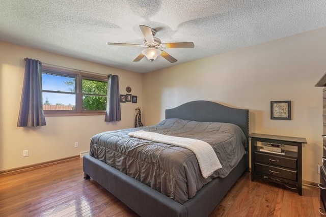 728 Schoolgate Road New Lenox, IL 60451 - Photo 11 of 24 a bedroom with a bed and wooden floor