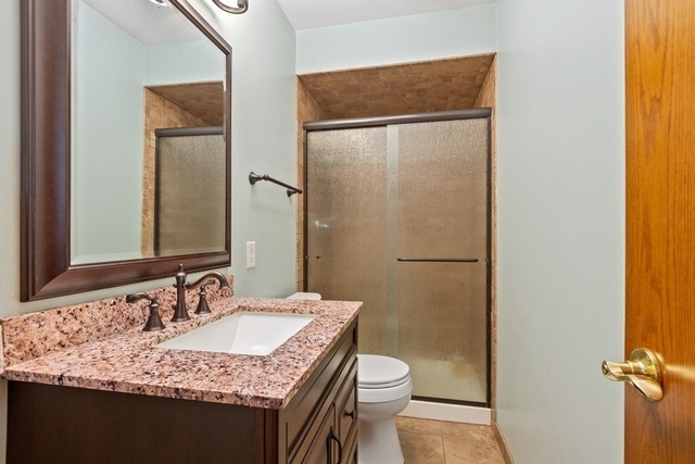 728 Schoolgate Road New Lenox, IL 60451 - Photo 12 of 24 a bathroom with a granite countertop sink and a mirror