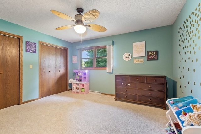728 Schoolgate Road New Lenox, IL 60451 - Photo 14 of 24 a bedroom with a bed and a chandelier