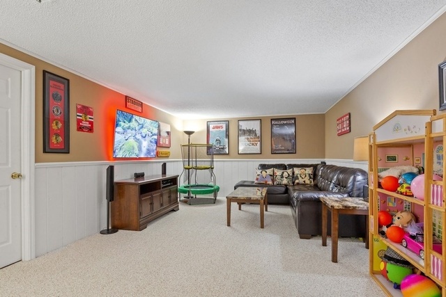 728 Schoolgate Road New Lenox, IL 60451 - Photo 16 of 24 a living room with furniture and a flat screen tv