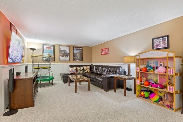 728 Schoolgate Road New Lenox, IL 60451 - Photo 17 of 24 a living room with furniture and a baby crib