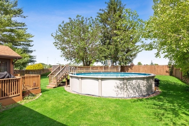 728 Schoolgate Road New Lenox, IL 60451 - Photo 21 of 24 a view of a deck with a bench and large trees