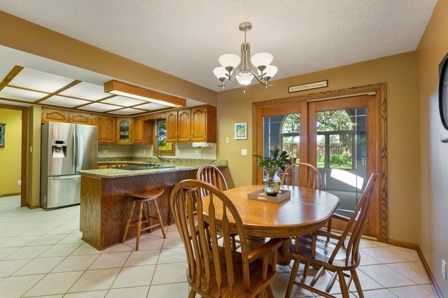 728 Schoolgate Road New Lenox, IL 60451 - Photo 5 of 24 a view of a dining room with furniture window and outside view