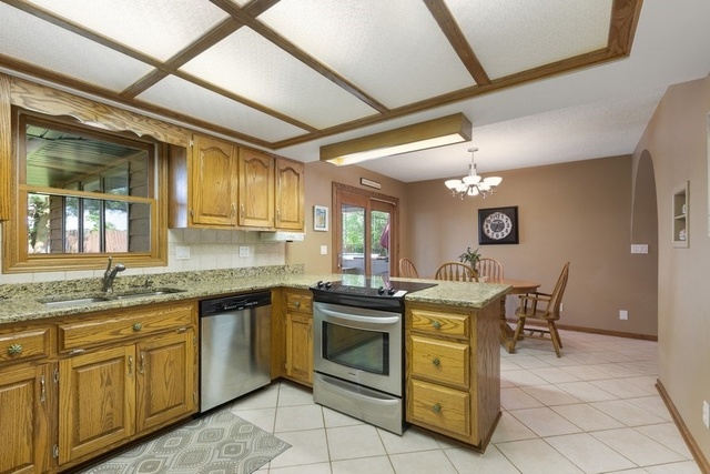 728 Schoolgate Road New Lenox, IL 60451 - Photo 8 of 24 a view of a kitchen counter space and windows