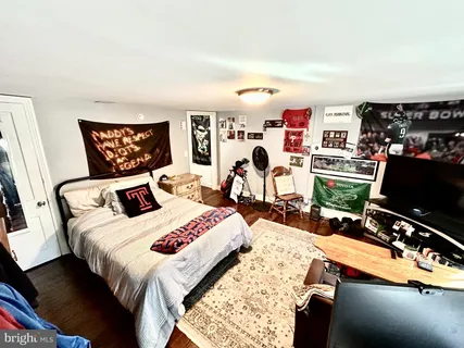 a bedroom with bed and a flat screen tv