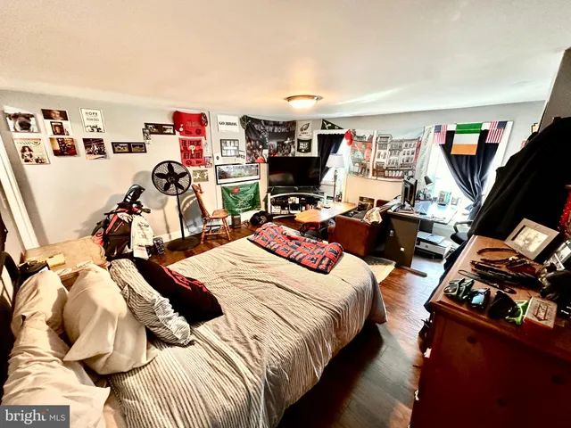 a kitchen with stainless steel appliances granite countertop a stove a sink dishwasher and a refrigerator with wooden floor