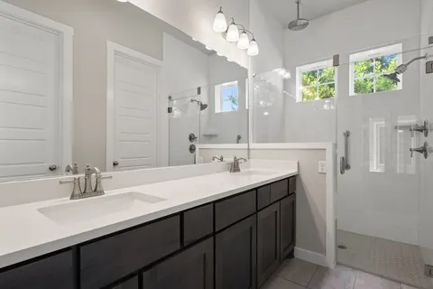 a bathroom with a sink double vanity and a mirror