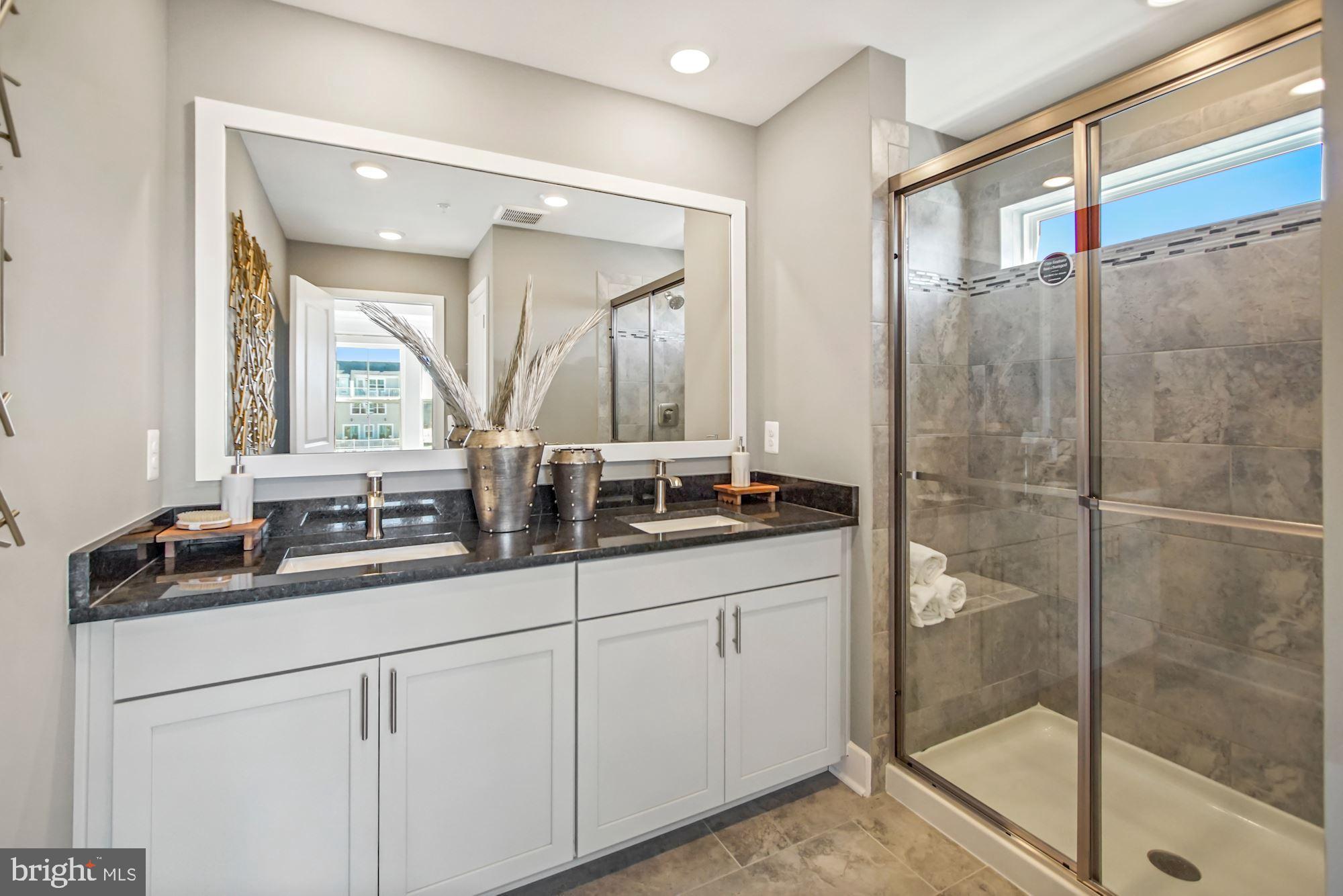 4151 Skipton Place White Plains, MD 20695 - Photo 16 of 27 a bathroom with double sink and a mirror