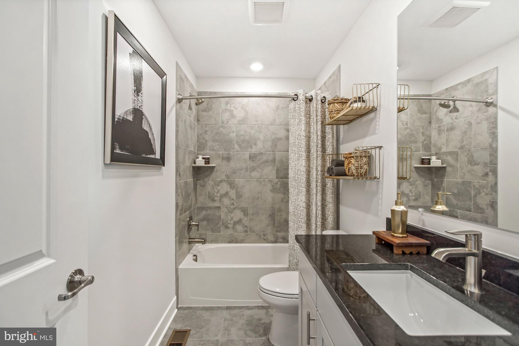 4151 Skipton Place White Plains, MD 20695 - Photo 20 of 27 a bathroom with a granite countertop sink toilet and shower