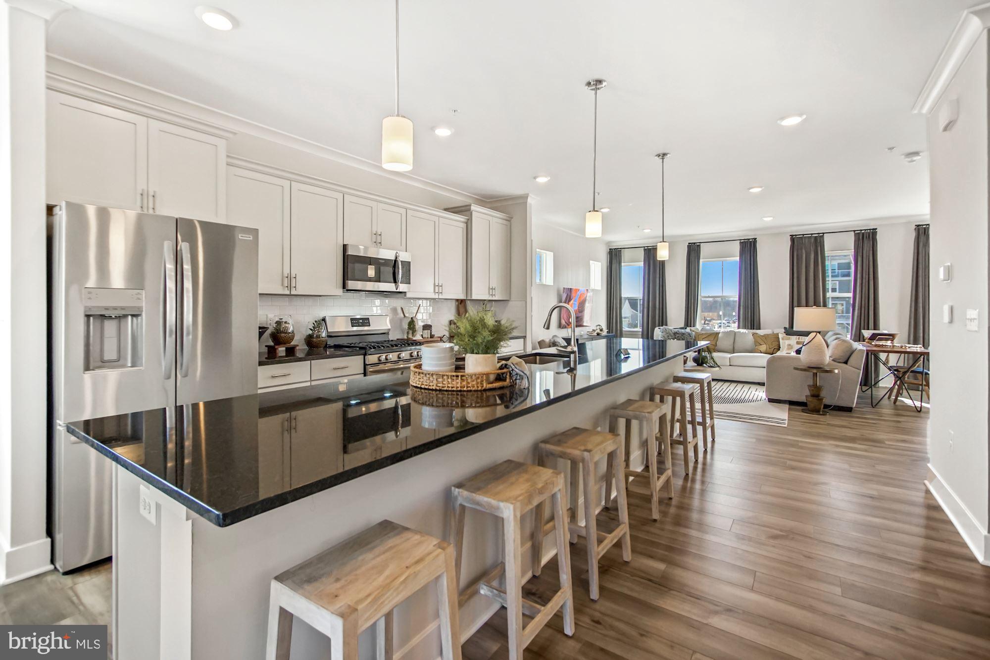 4151 Skipton Place White Plains, MD 20695 - Photo 2 of 27 a kitchen with stainless steel appliances granite countertop a refrigerator a stove top oven a sink dishwasher and white cabinets with wooden floor
