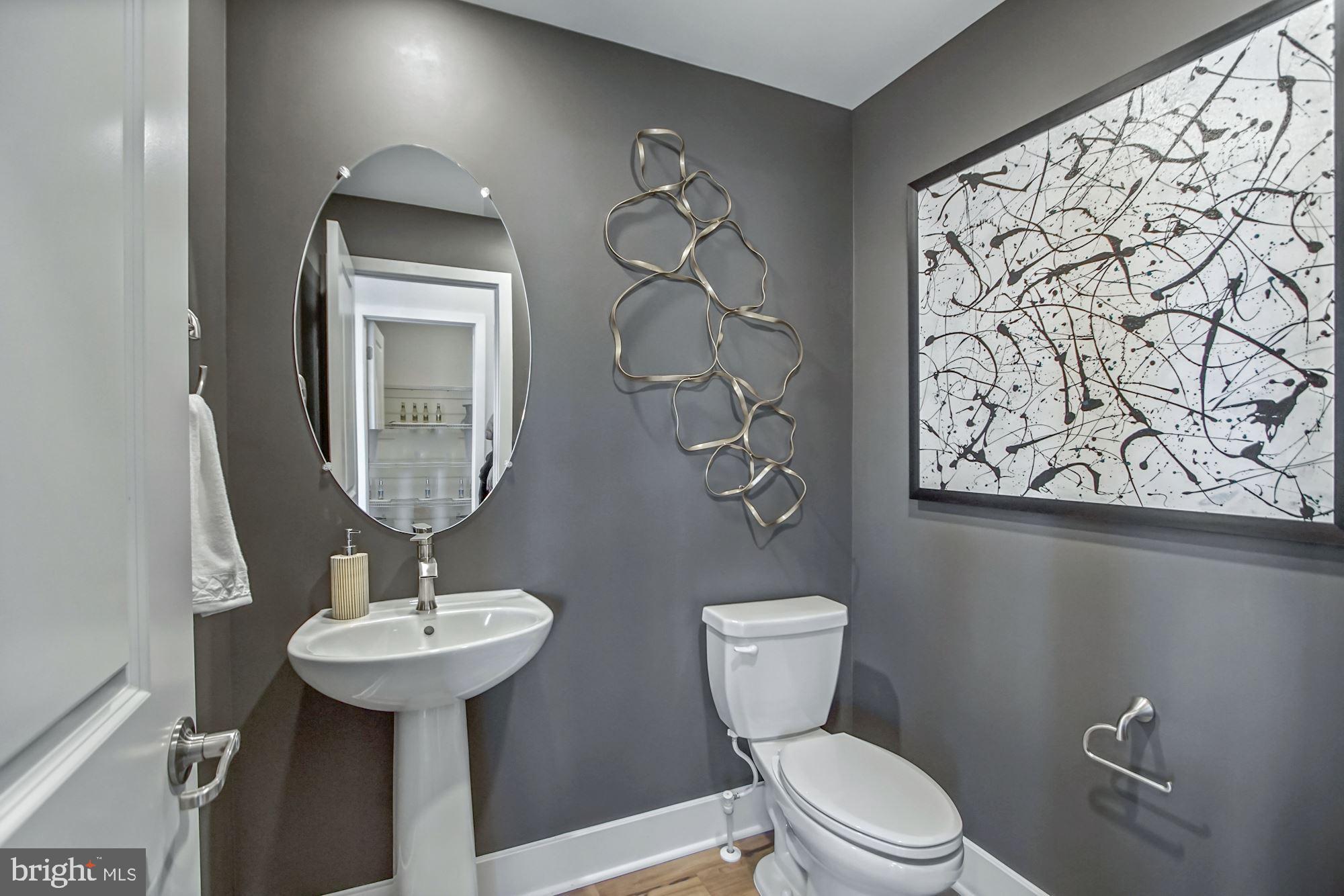 4151 Skipton Place White Plains, MD 20695 - Photo 24 of 27 a bathroom with a toilet sink and mirror