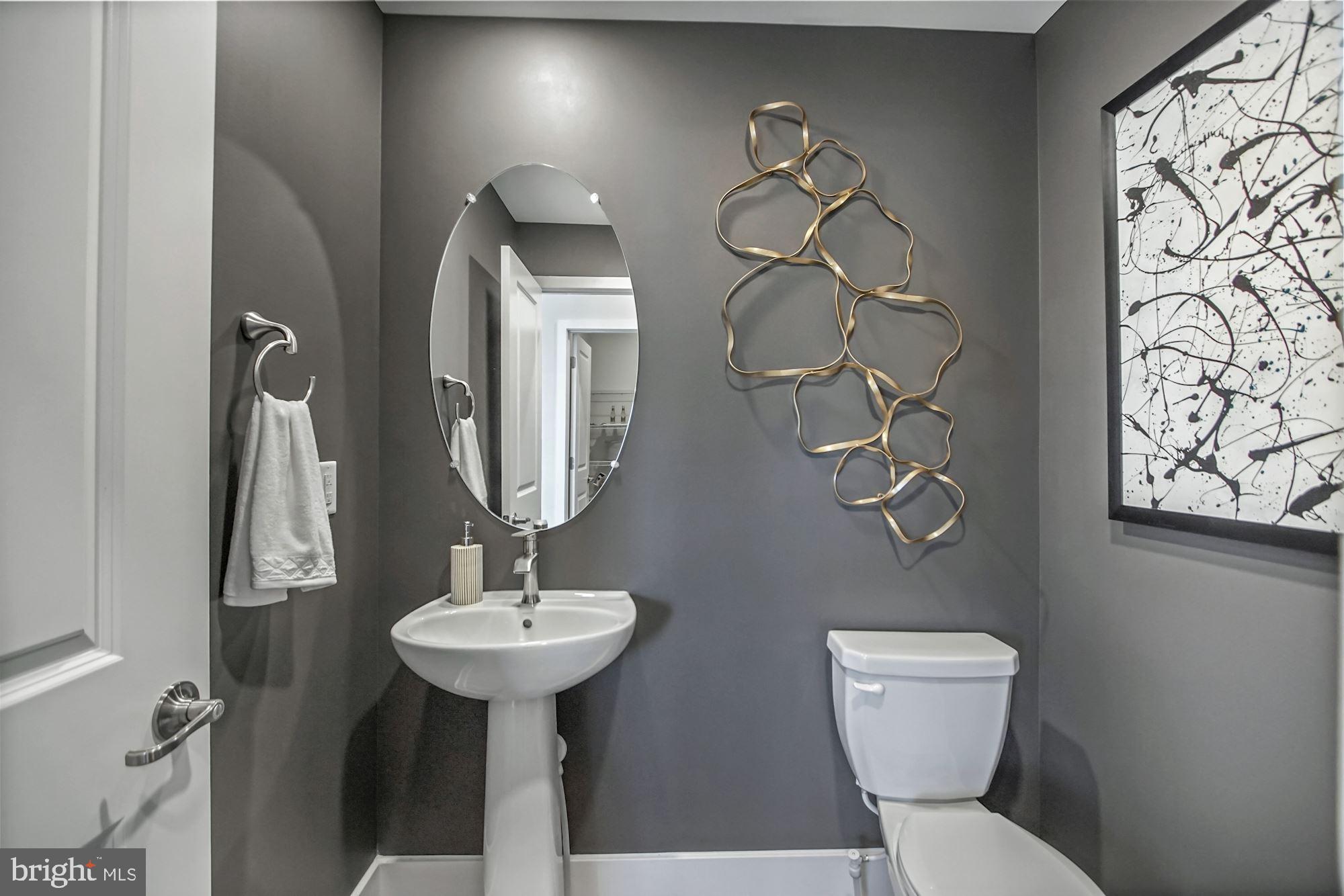 4151 Skipton Place White Plains, MD 20695 - Photo 25 of 27 a bathroom with a toilet sink and mirror