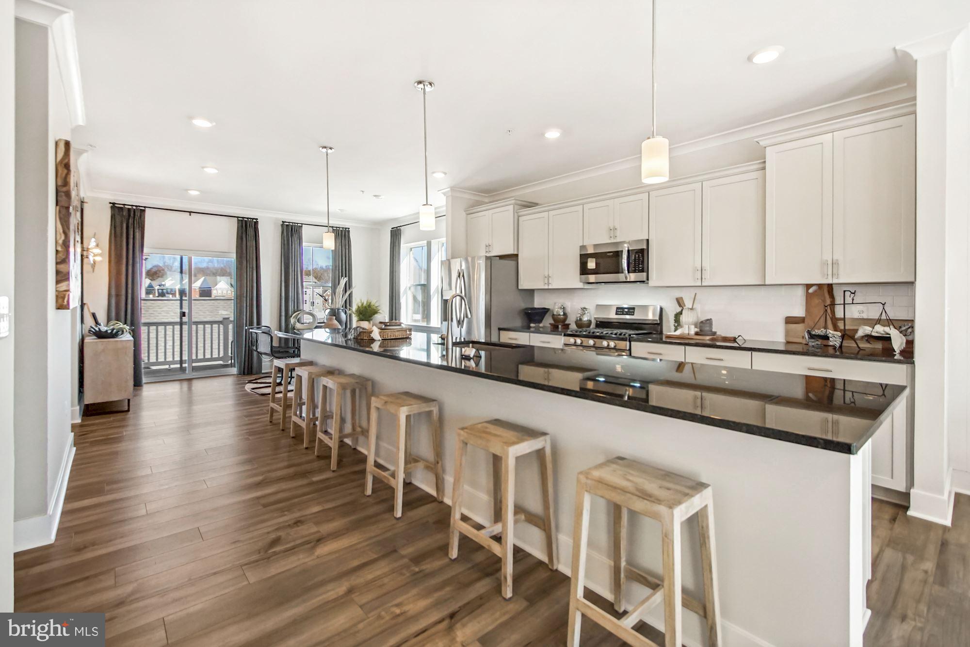 4151 Skipton Place White Plains, MD 20695 - Photo 3 of 27 a large kitchen with lots of counter space a sink appliances and cabinets